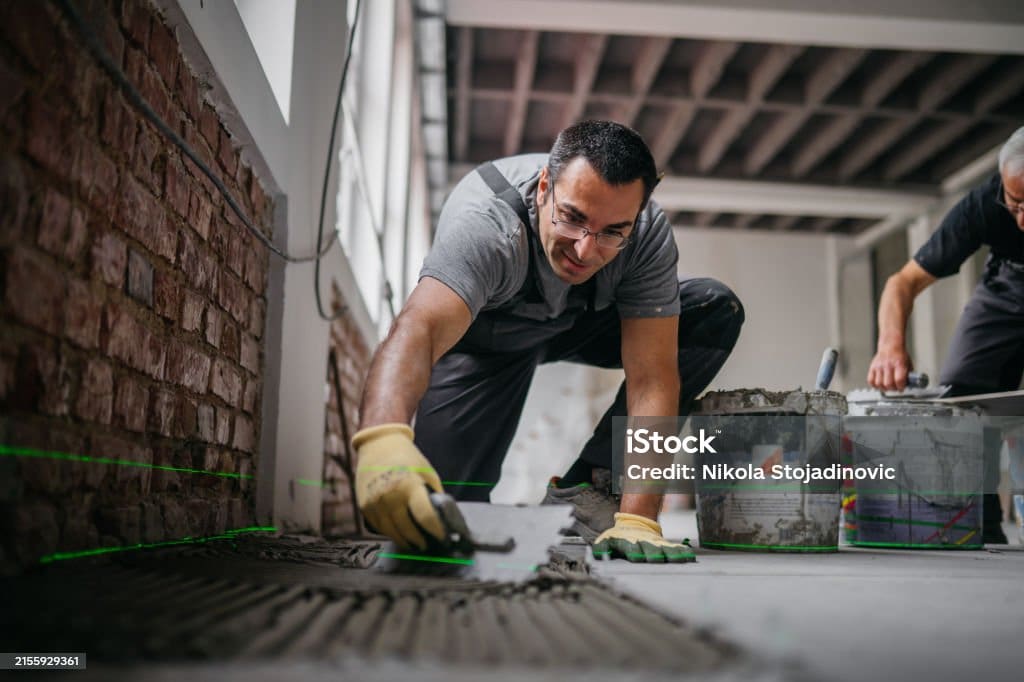 Two men installing tiles